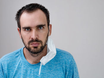 Portrait of young man against white background