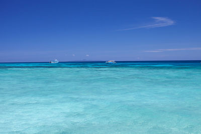 Sailboat in sea against blue sky