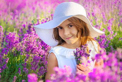 Portrait of smiling girl with flowers in farm