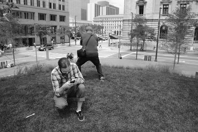 High angle view of men on grass in city