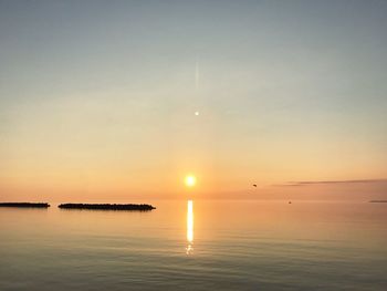 Scenic view of sea against clear sky during sunset