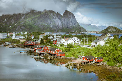 Scenic view of lake and buildings against sky