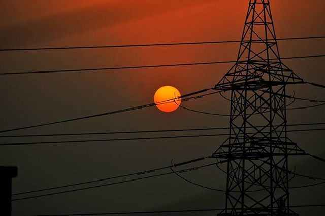 low angle view, electricity, power line, power supply, cable, electricity pylon, connection, sunset, sky, orange color, fuel and power generation, silhouette, technology, power cable, lighting equipment, dusk, nature, no people, outdoors, sun