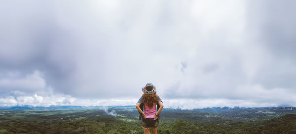 Rear view of woman standing against sky