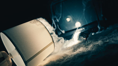 Low angle view of illuminated lighting equipment