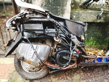 Close-up of abandoned motorcycle on street