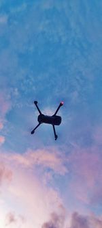 Low angle view of airplane flying against sky