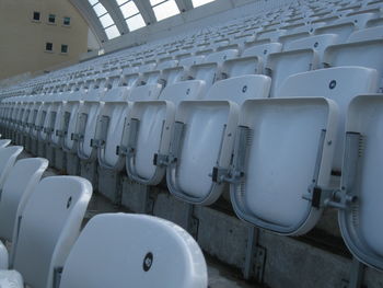 Close-up of folded white seats in rows