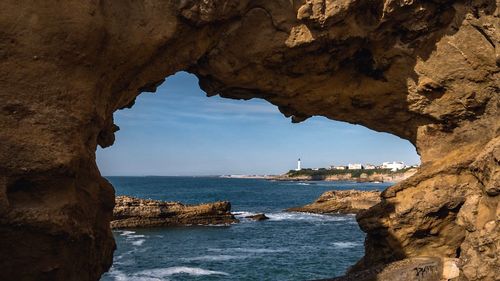 Scenic view of sea seen through cave