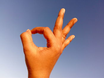 Human hand forming ok sign