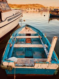 High angle view of empty fishing boat moored at lake