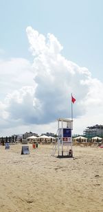 Lifeguard hut on beach against sky