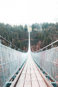 Footbridge against clear sky