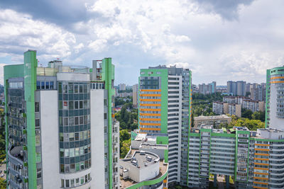 Modern residential buildings with windows against cloudy sky