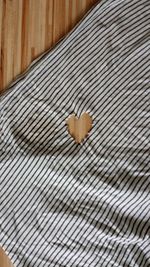 High angle view of heart shape on bed