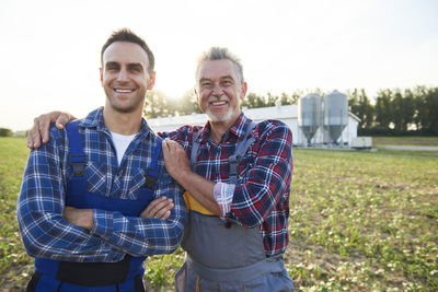 Portrait of two farmers proud of their farm
