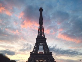 Low angle view of eiffel tower against cloudy sky