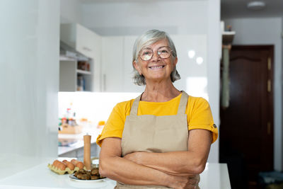 Portrait of young woman using mobile phone at home