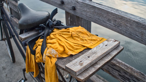 High angle view of yellow fabric on bicycle against railing