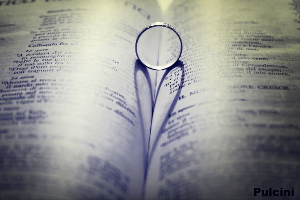 indoors, text, close-up, still life, western script, communication, selective focus, table, book, refreshment, drink, focus on foreground, paper, glass - material, no people, finance, education, wealth, bottle, reflection