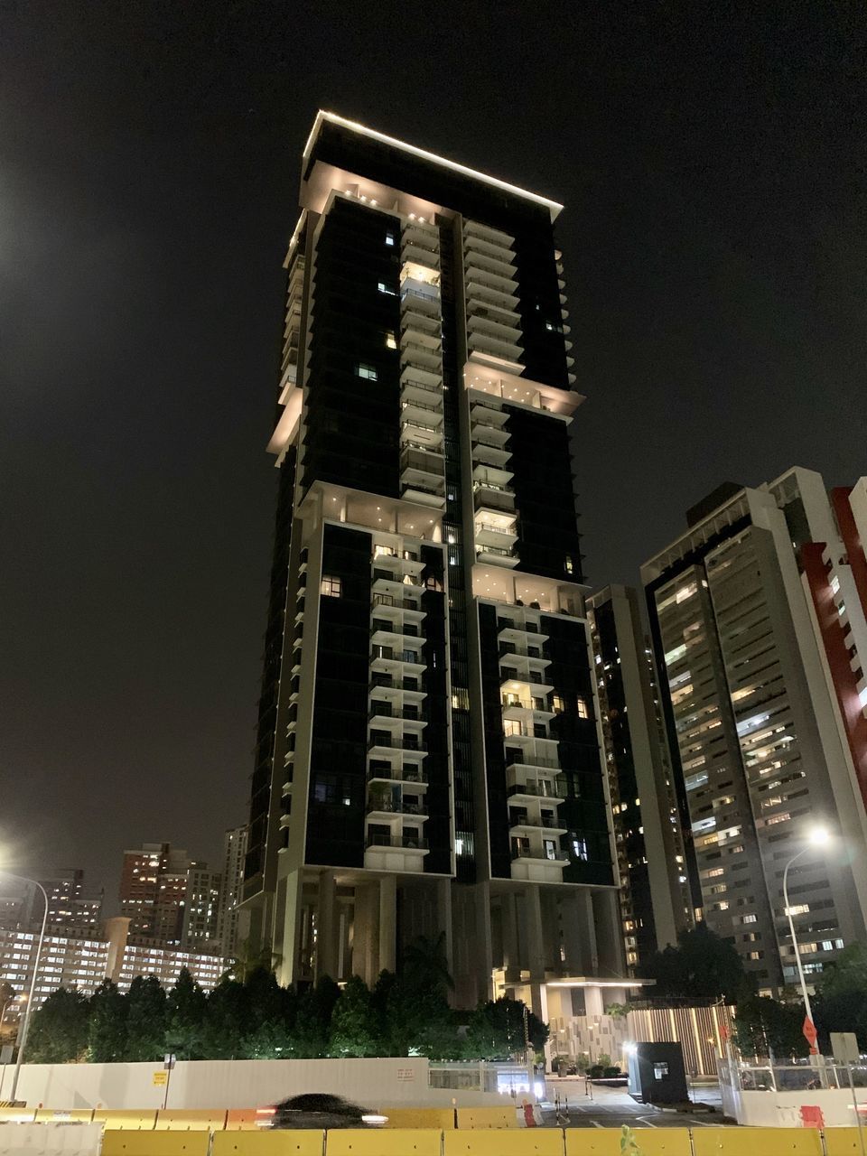 LOW ANGLE VIEW OF ILLUMINATED BUILDINGS AGAINST SKY