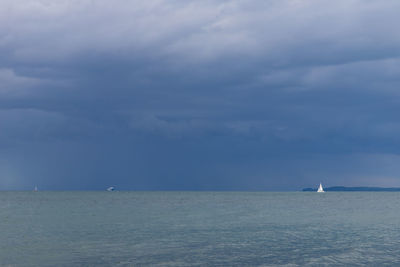 Sailboat sailing on sea against sky