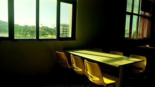 Empty chairs and table in building