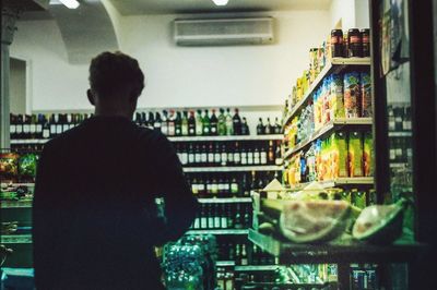 Rear view of man standing in store