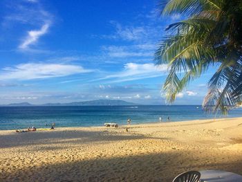 Scenic view of beach against blue sky