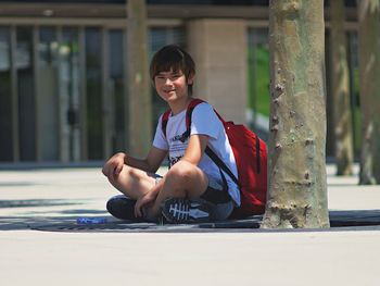 Portrait of boy sitting outdoors