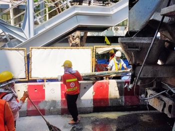 Rear view of people working at construction site