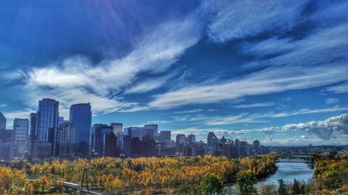 Buildings in city against cloudy sky