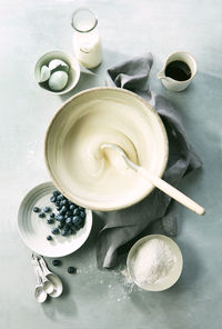 Preparing buttermilk blueberry pancakes with ingredients