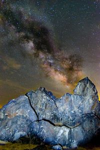 Scenic view of landscape against sky at night