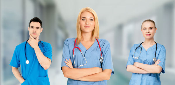 Young woman standing in front of two people