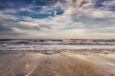 View of beach against cloudy sky