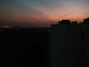 Silhouette cityscape against sky during sunset