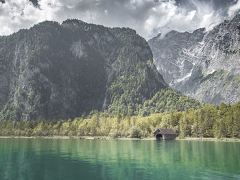 Scenic view of lake in forest against sky