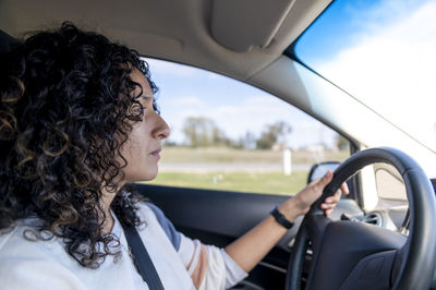 Portrait of young woman in car