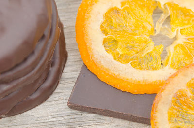 Close-up of chocolates with oranges on table