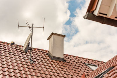 Low angle view of roof and building against sky