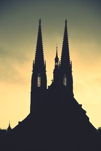 Low angle view of silhouette building against sky during sunset