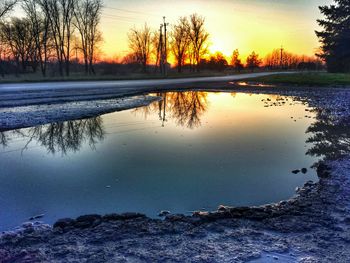 Scenic view of lake at sunset