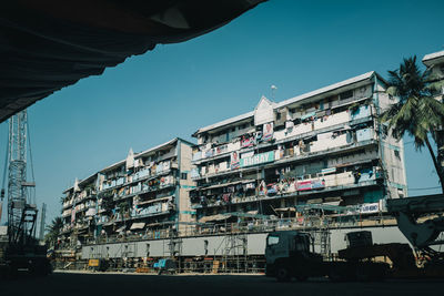 Buildings against clear blue sky in city