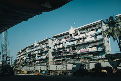 Buildings against clear blue sky in poor city