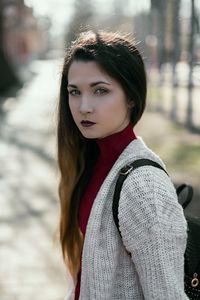 Portrait of beautiful young woman standing in winter