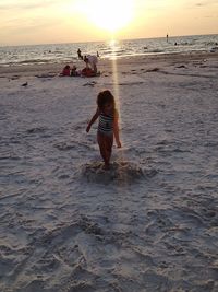 People on beach at sunset