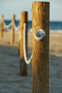 Close-up of wooden post at seaside