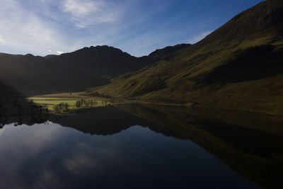 Scenic view of lake and mountains against sky