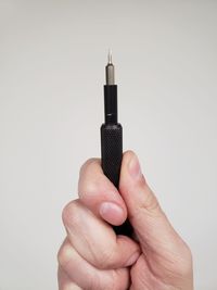 Close-up of hand holding black background